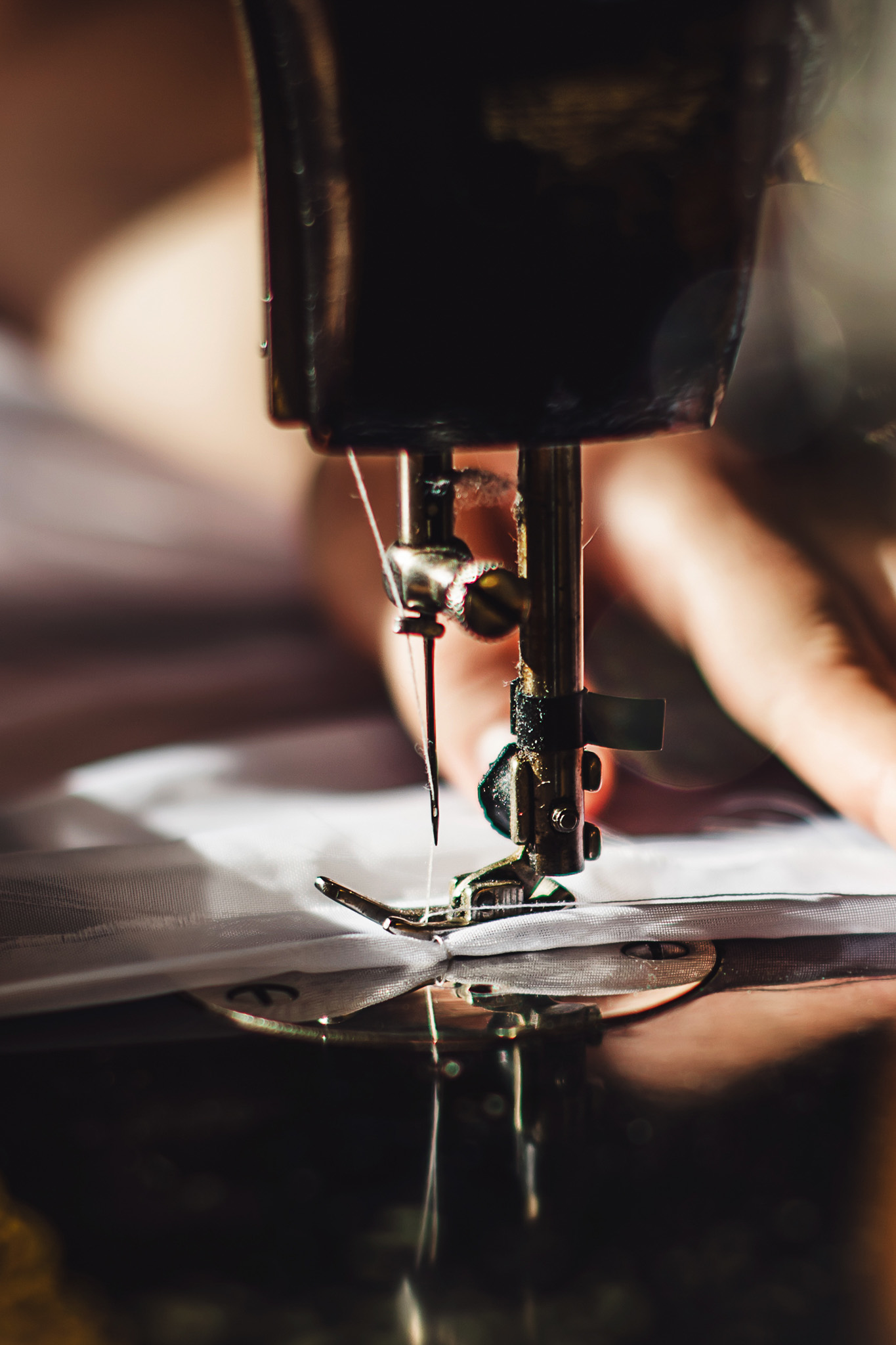 Vintage sewing machine and woman's hands, sewing process